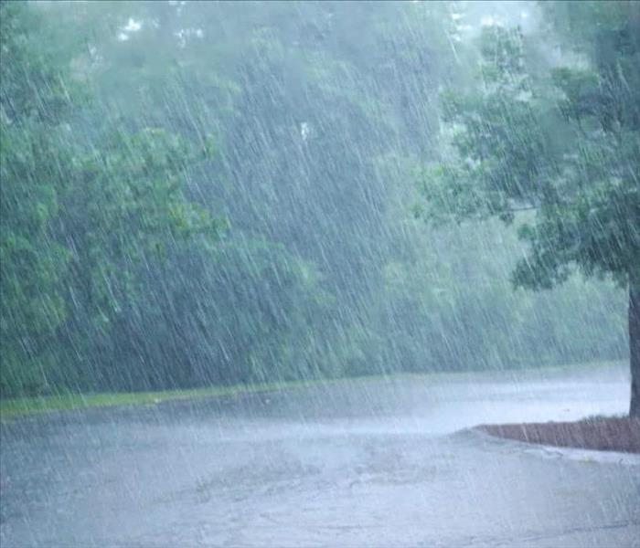 Heavy rains fall and flood a parking lot
