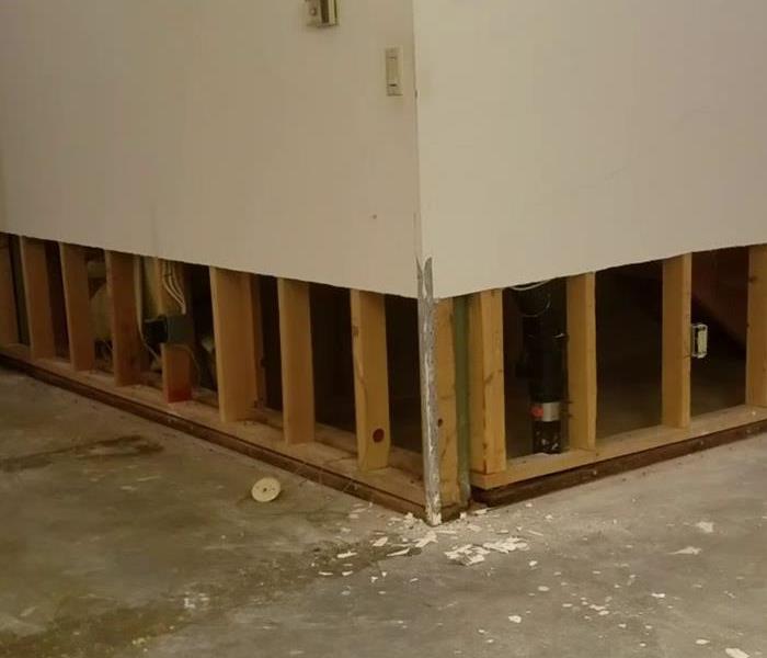 A wall has 2feet of drywall removed at the base to allow proper drying