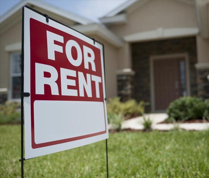 Property rental sign stands in front of home